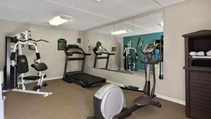 A fitness center with cardio machines, a treadmill, and a rowing machine.