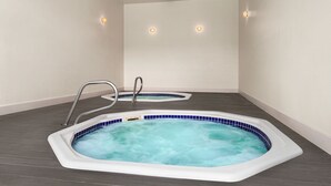 A spa room with two hot tubs, a metal ladder, and a ceiling vent. - Holiday Inn Ocean City by IHG (Ocean City)