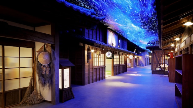 A traditional Japanese building with tatami mat flooring, shoji screens, and a starry sky projection on the ceiling.