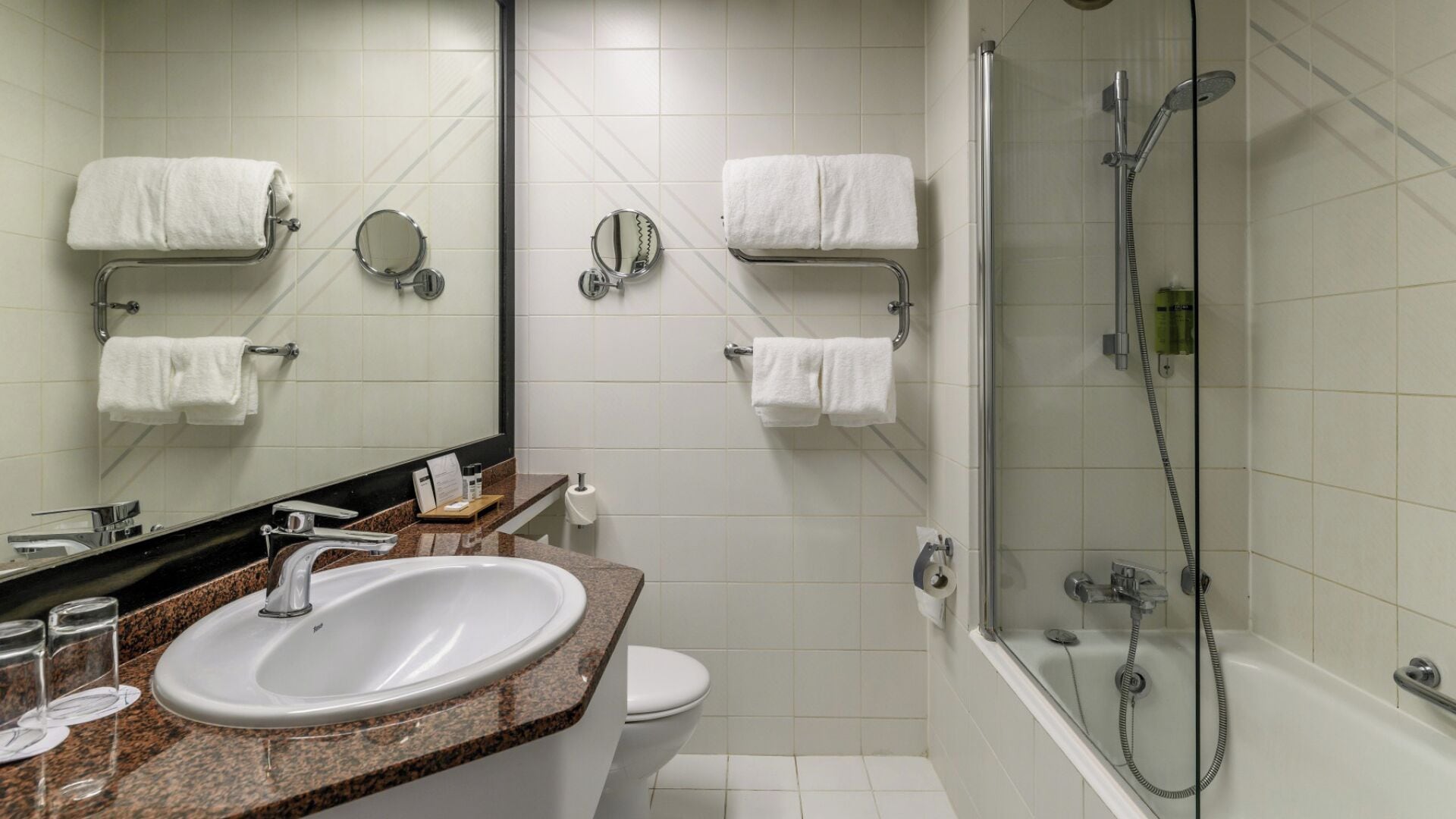 A modern bathroom with a sink, toilet, and shower.
