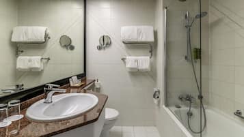 Un baño moderno con lavamanos, inodoro y ducha.