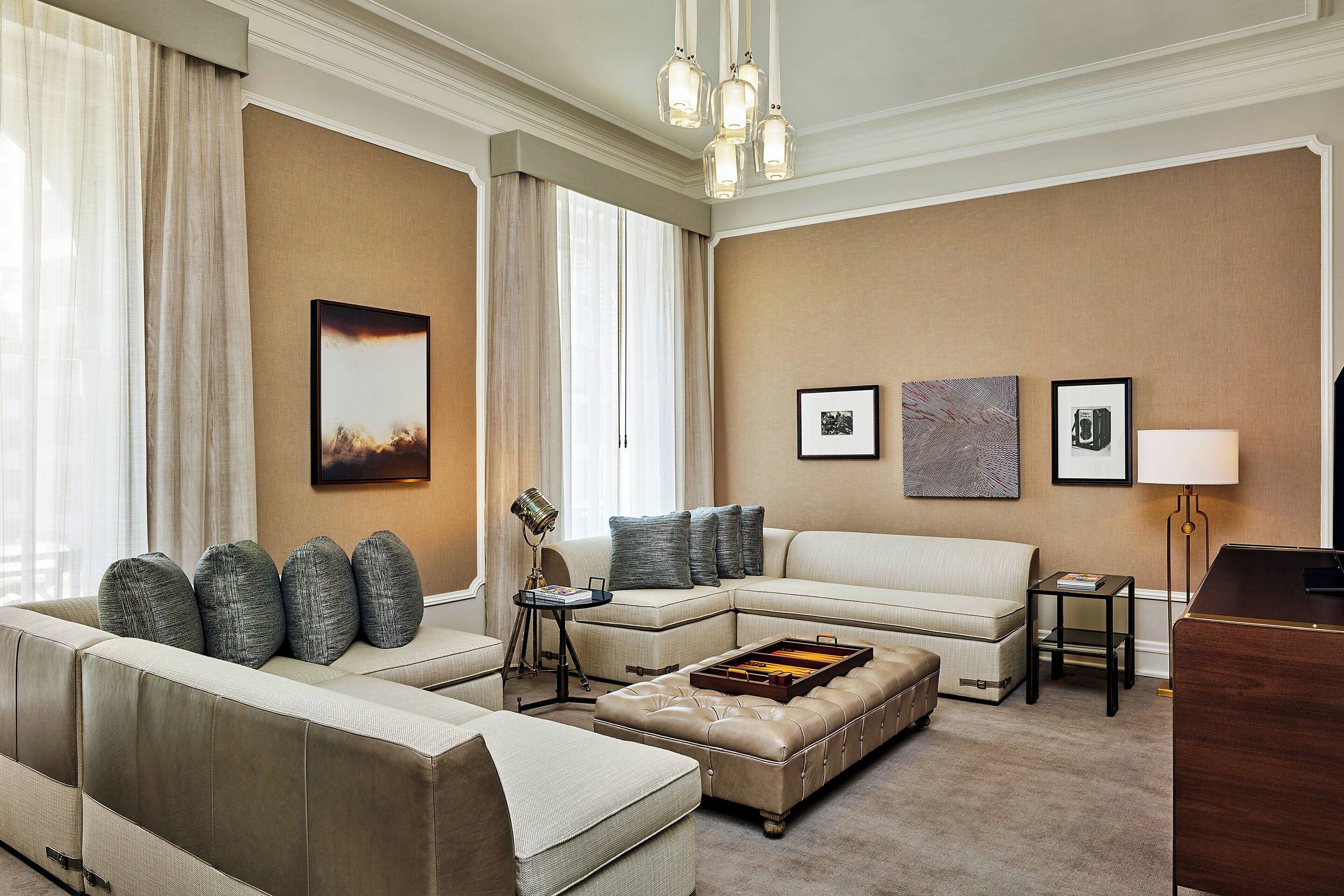 A modern living room with a sectional sofa, a chaise lounge, a coffee table, and a desk.