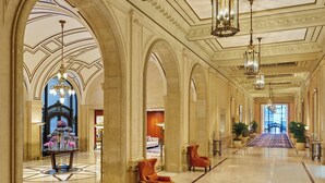 A grand hallway with high ceilings, ornate columns, and chandeliers. - Palace Hotel, a Luxury Collection Hotel, San Francisco (San Francisco)