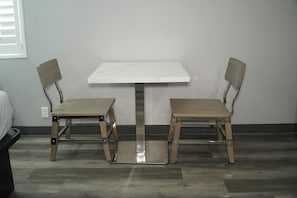 A small room with a white table and two chairs.