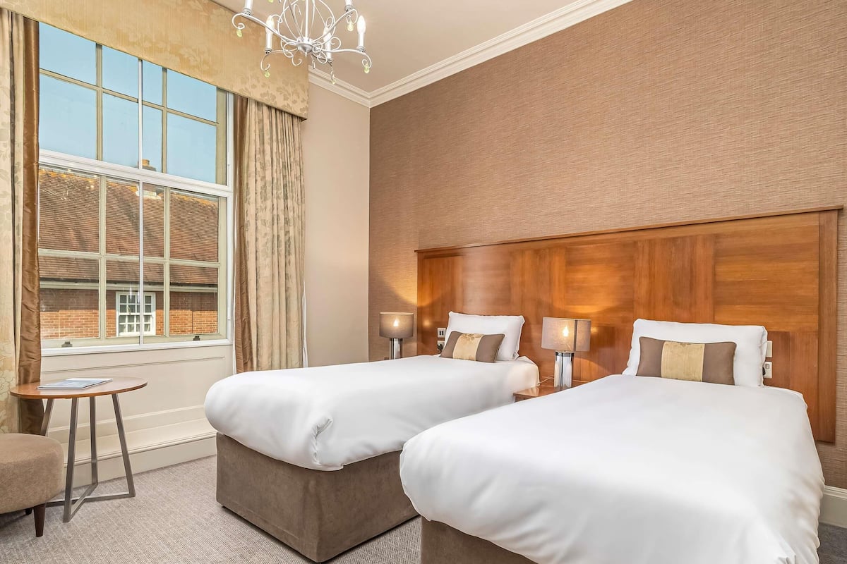 Premium bedding, desk, laptop workspace, blackout drapes