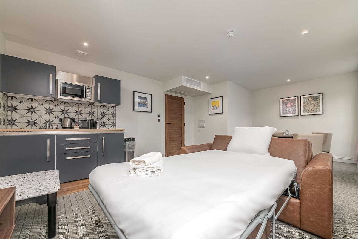 Premium bedding, desk, laptop workspace, blackout drapes