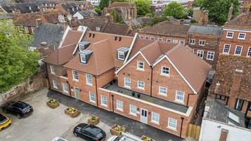 A multi-story brick building with a flat roof and multiple windows.