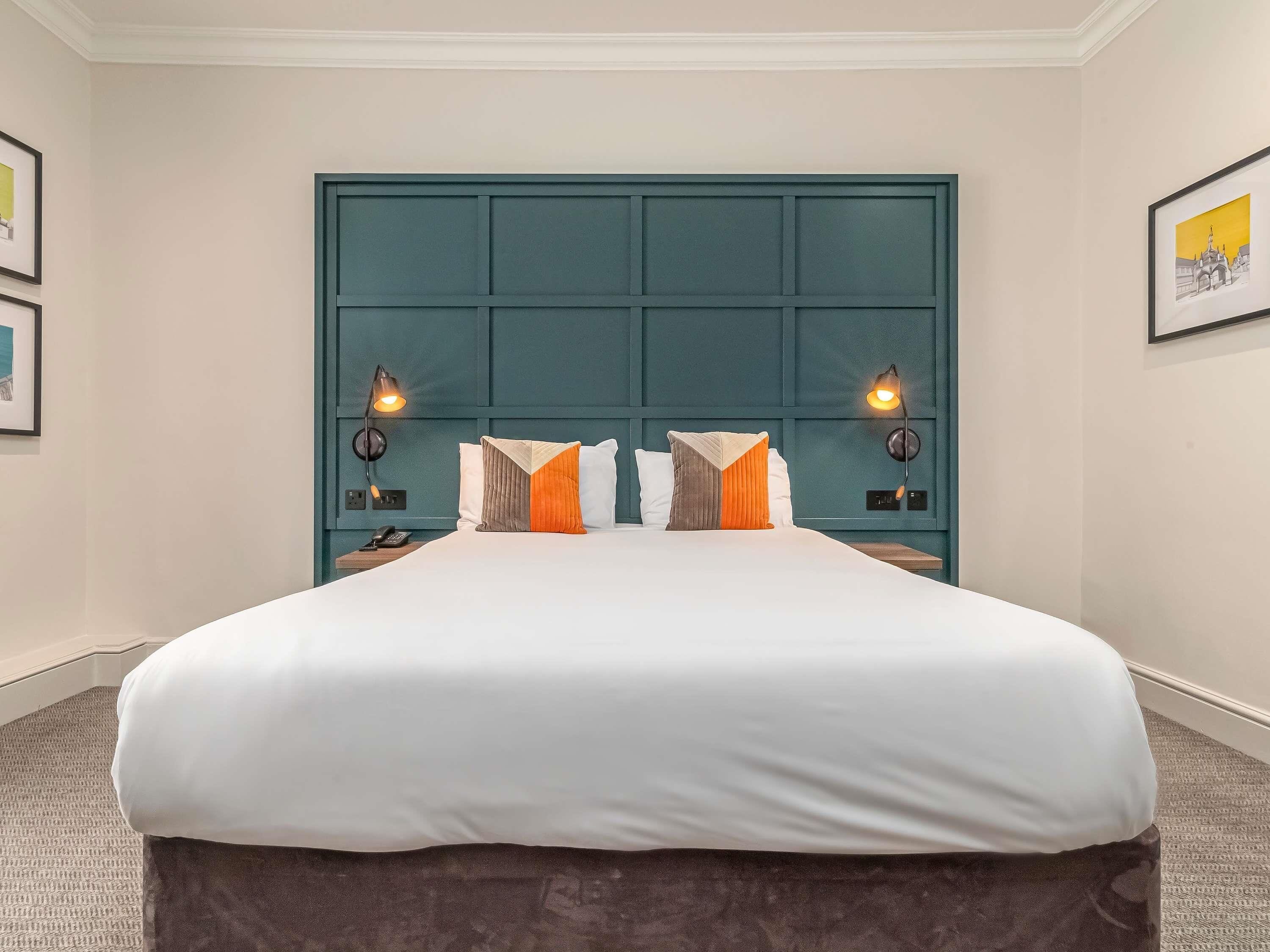 Premium bedding, desk, laptop workspace, blackout drapes