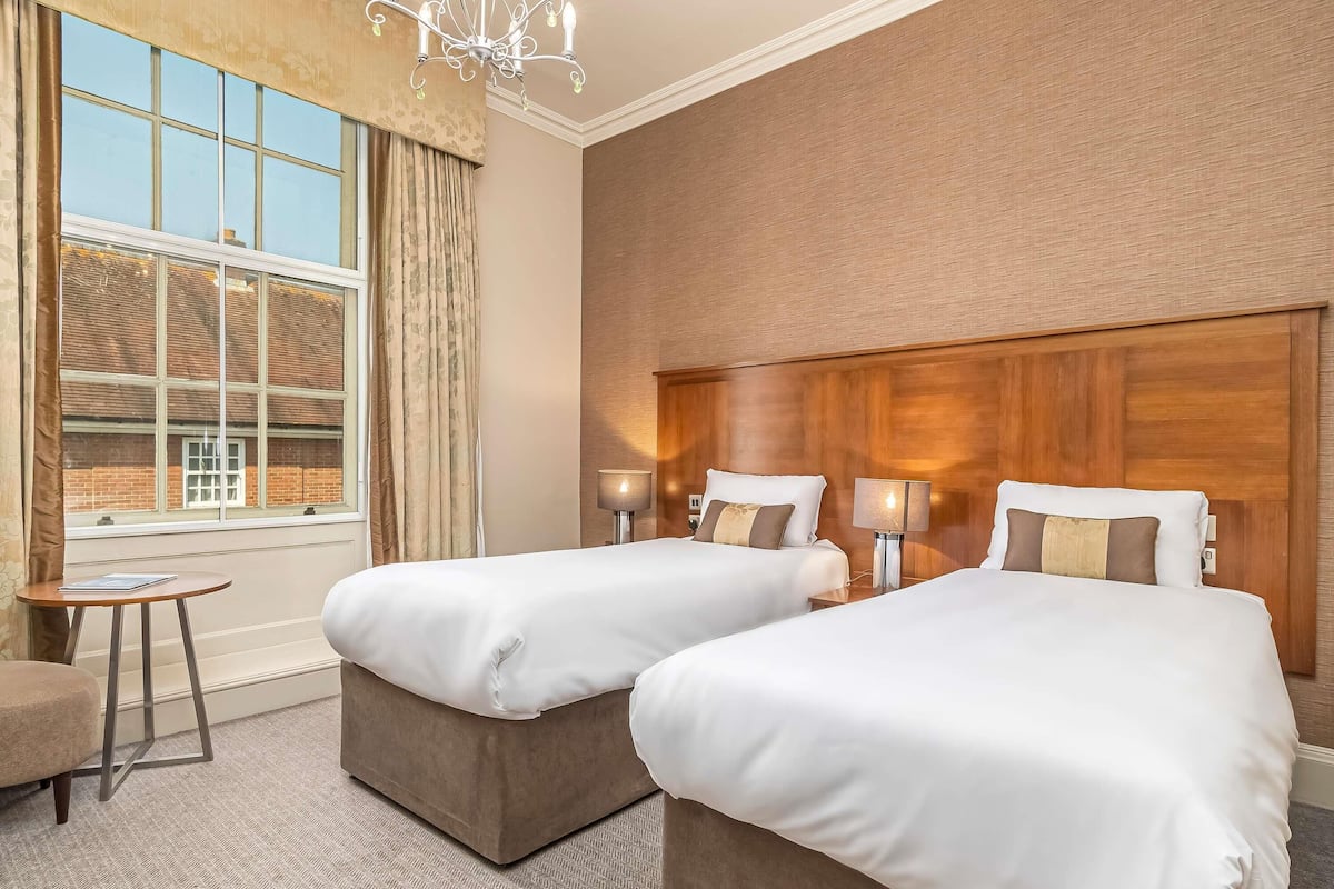 Premium bedding, desk, laptop workspace, blackout drapes