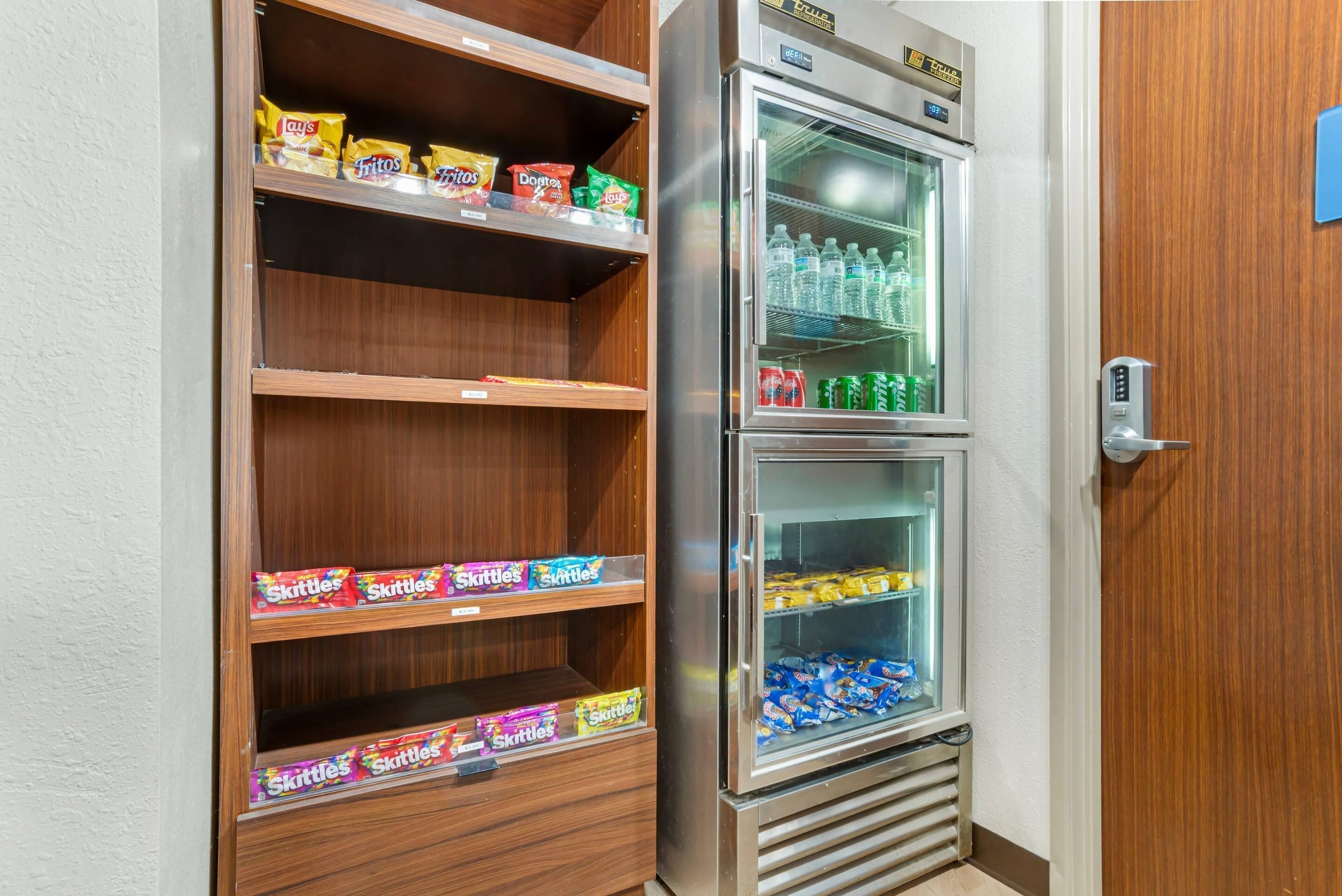 A vending machine with snacks and drinks, including Lay's chips and Coca-Cola.