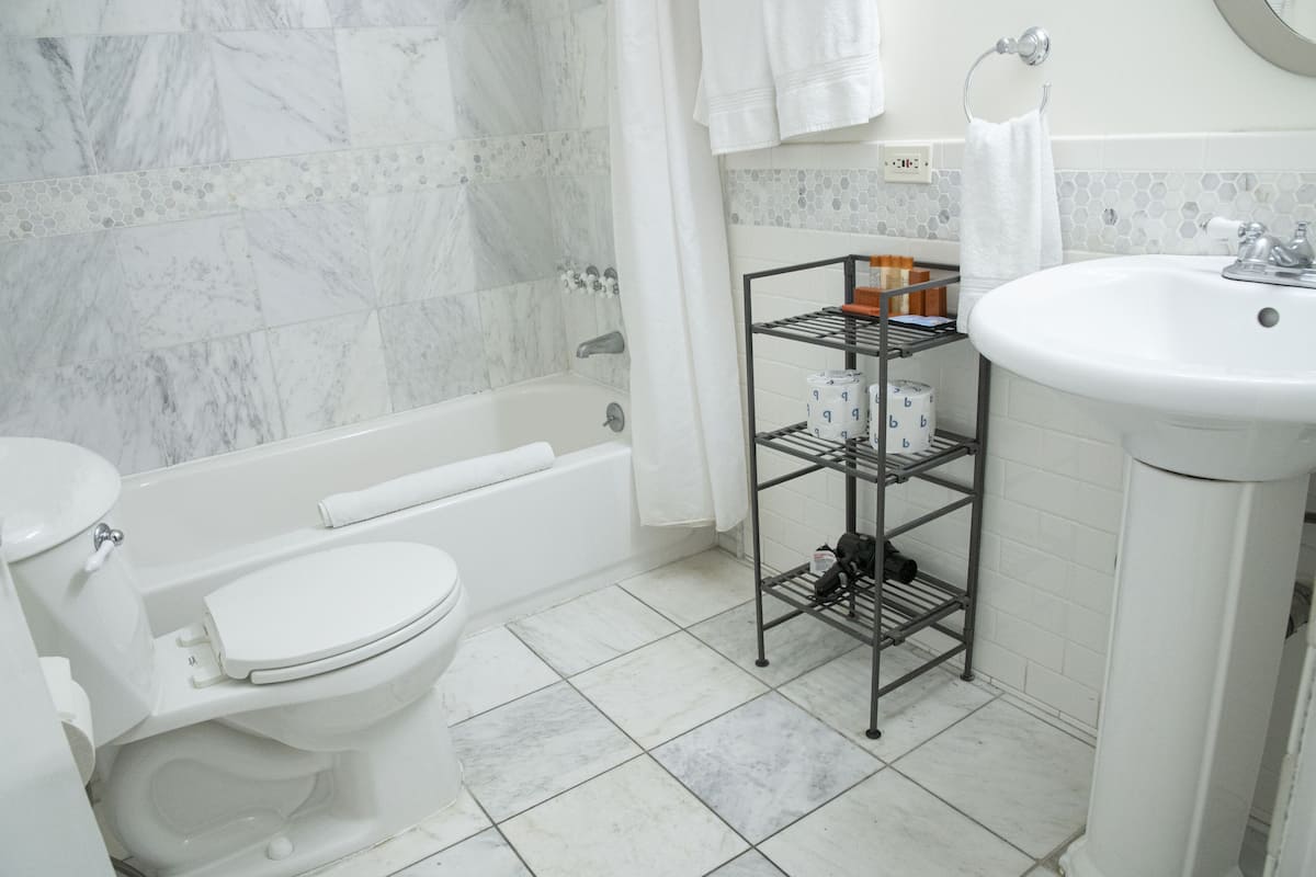 combined shower/bathtub, designer toiletries, hair dryer, bathrobes