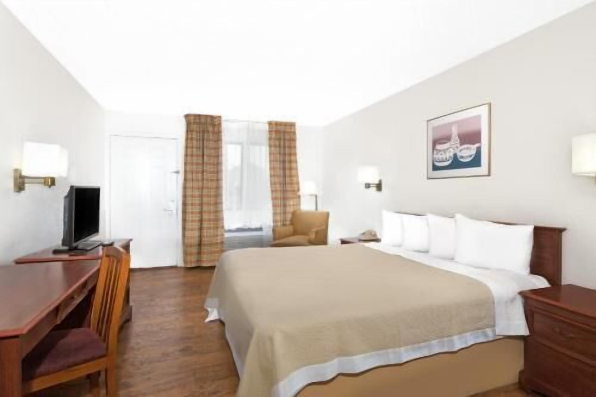 Escritorio, cortinas blackout y tabla de planchar con plancha 