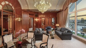 A spacious room with a large chandelier, multiple seating areas, and large windows offering a view. - Maritim Hotel Bad Wildungen (Bad Wildungen)
