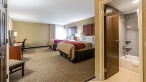 A hotel room with two beds, a desk, a chair, a shower, and a bathroom with a bathtub. - Comfort Inn & Suites Lexington - Hamburg I-75 (Lexington)