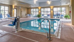An indoor swimming pool with clear lanes, lounge chairs, and a lifeguard chair. - Comfort Inn & Suites Lexington - Hamburg I-75 (Lexington)