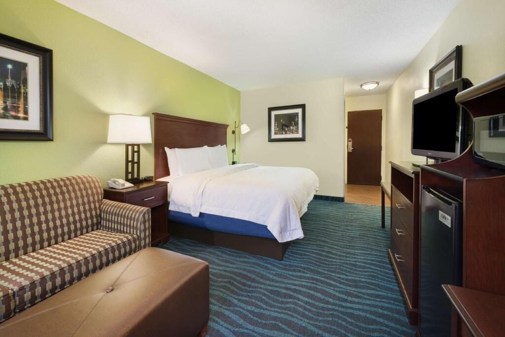Premium bedding, desk, laptop workspace, blackout curtains