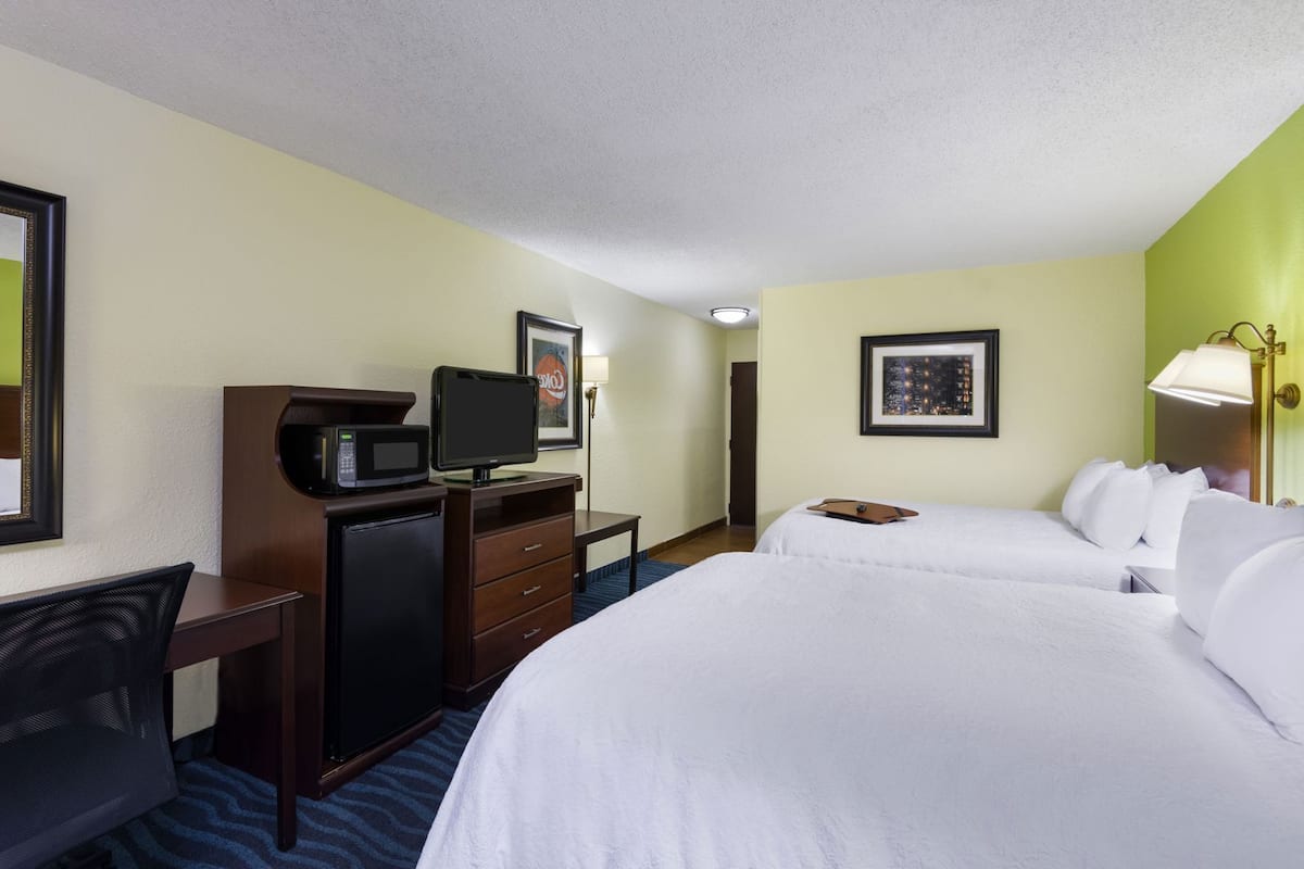 Premium bedding, desk, laptop workspace, blackout curtains
