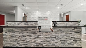 A reception desk with a stone-textured backdrop and a sign reading "HOMETOWNE STUDIOS."