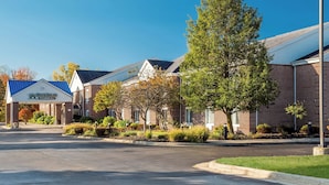 A row of brick buildings with a sign for Home Rowne Studios.