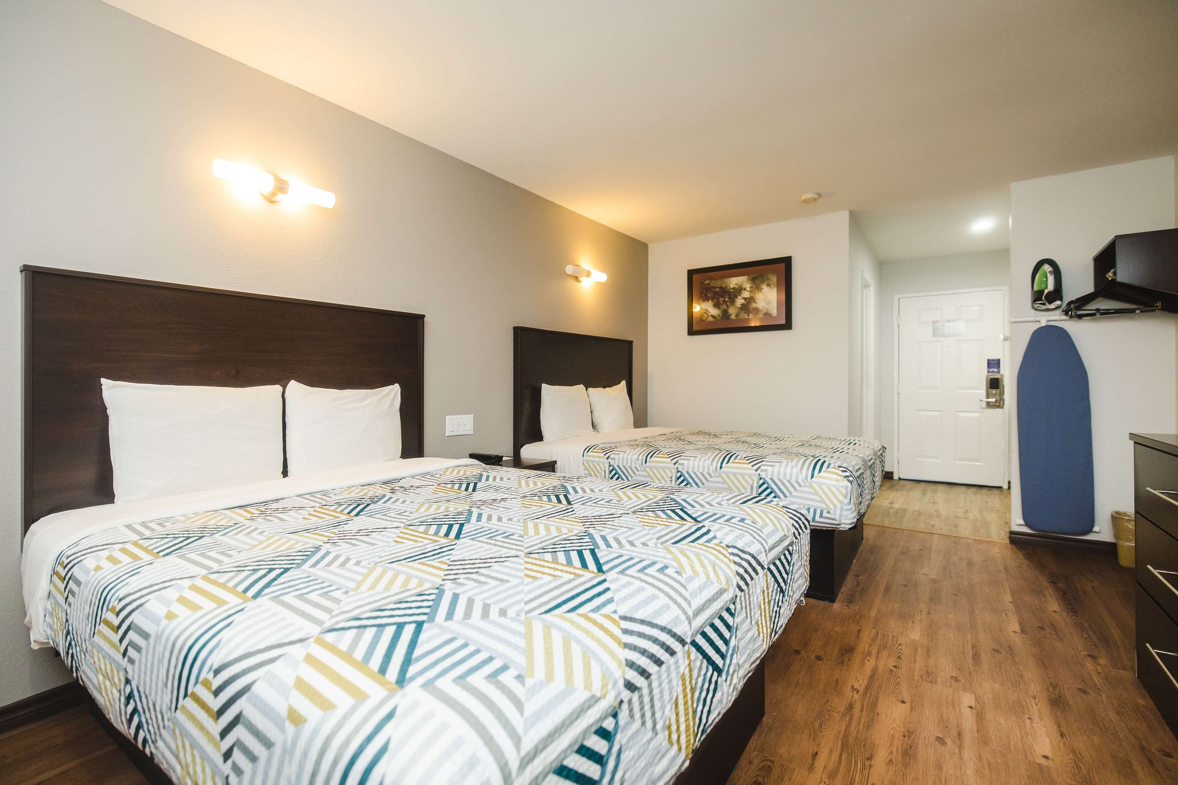 Premium bedding, desk, laptop workspace, iron/ironing board