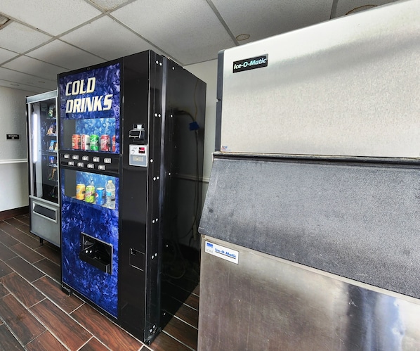 A vending machine labeled "COLD DRINKS" with a selection of beverages and a control panel.