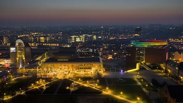 A cityscape at night with illuminated buildings and a prominent structure with a dome.