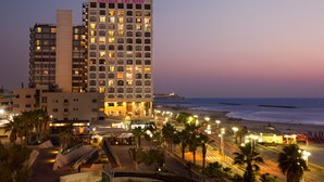 A hotel with multiple floors, a beach view, and a McDonald's restaurant. - Orchid Tel Aviv (Tel Aviv)