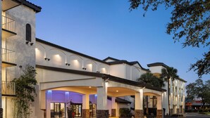 A hotel with a modern facade, multiple entry points, and a well-lit entrance area.