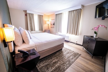 In-room safe, desk, laptop workspace, soundproofing at Mai Hana Hotel- Intl Drive, Trademark Collection by Wyndham