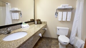 A bathroom with a granite sink, a toilet, and a shower area. - Holiday Inn Express Jamestown by IHG (Jamestown)