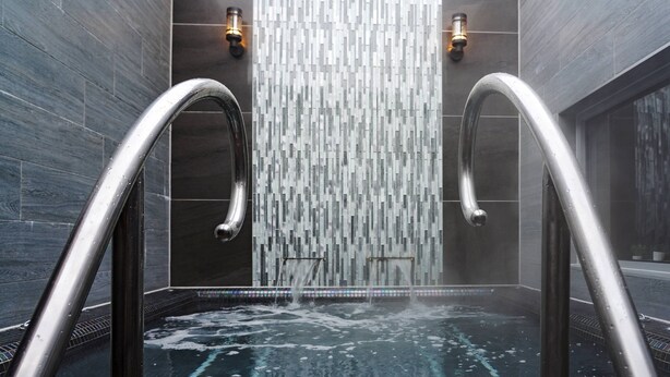 A modern bathroom with a glass shower enclosure, chrome fixtures, and a tiled floor. - Gomersal Park Hotel (Cleckheaton)