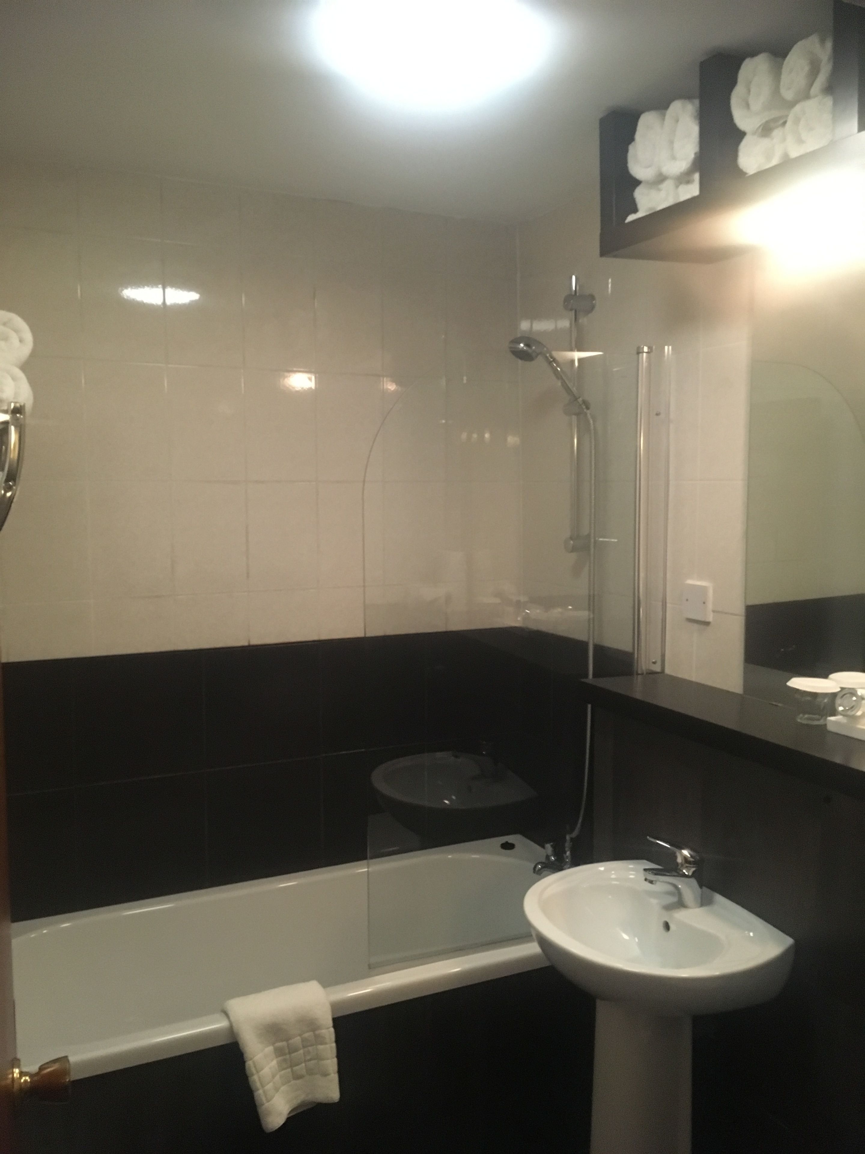 A bathroom with a bathtub, a sink, a toilet, and a shower.