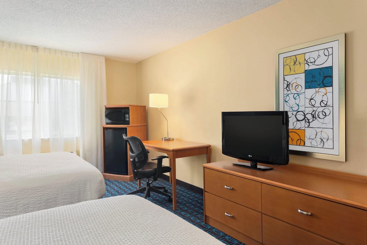 Premium bedding, pillow-top beds, desk, laptop workspace