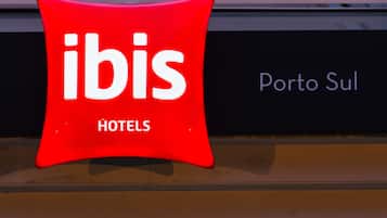A red sign with the word "ibis" and "HOTELS" indicating a hotel named ibis.