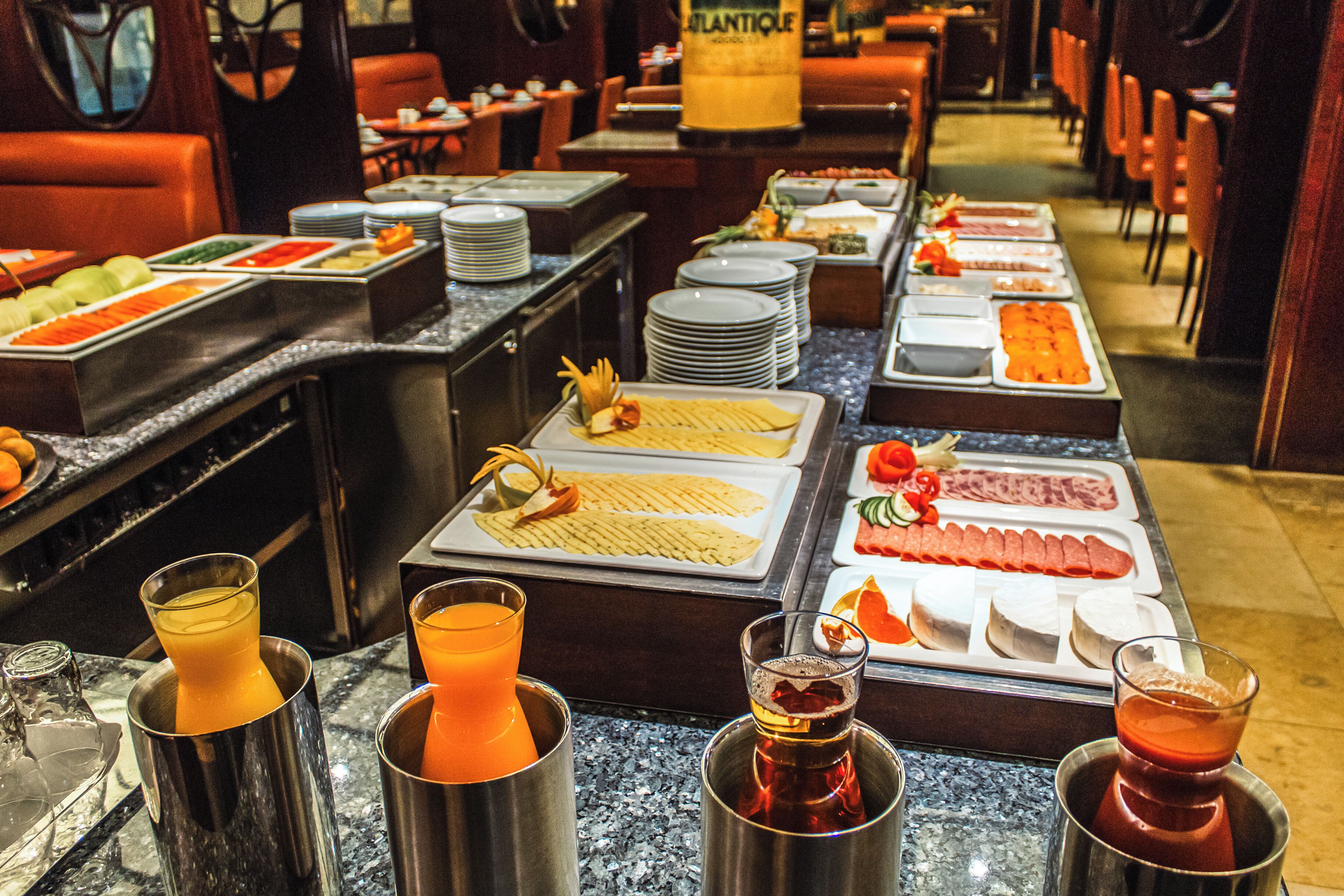 A buffet with various food items and drinks.