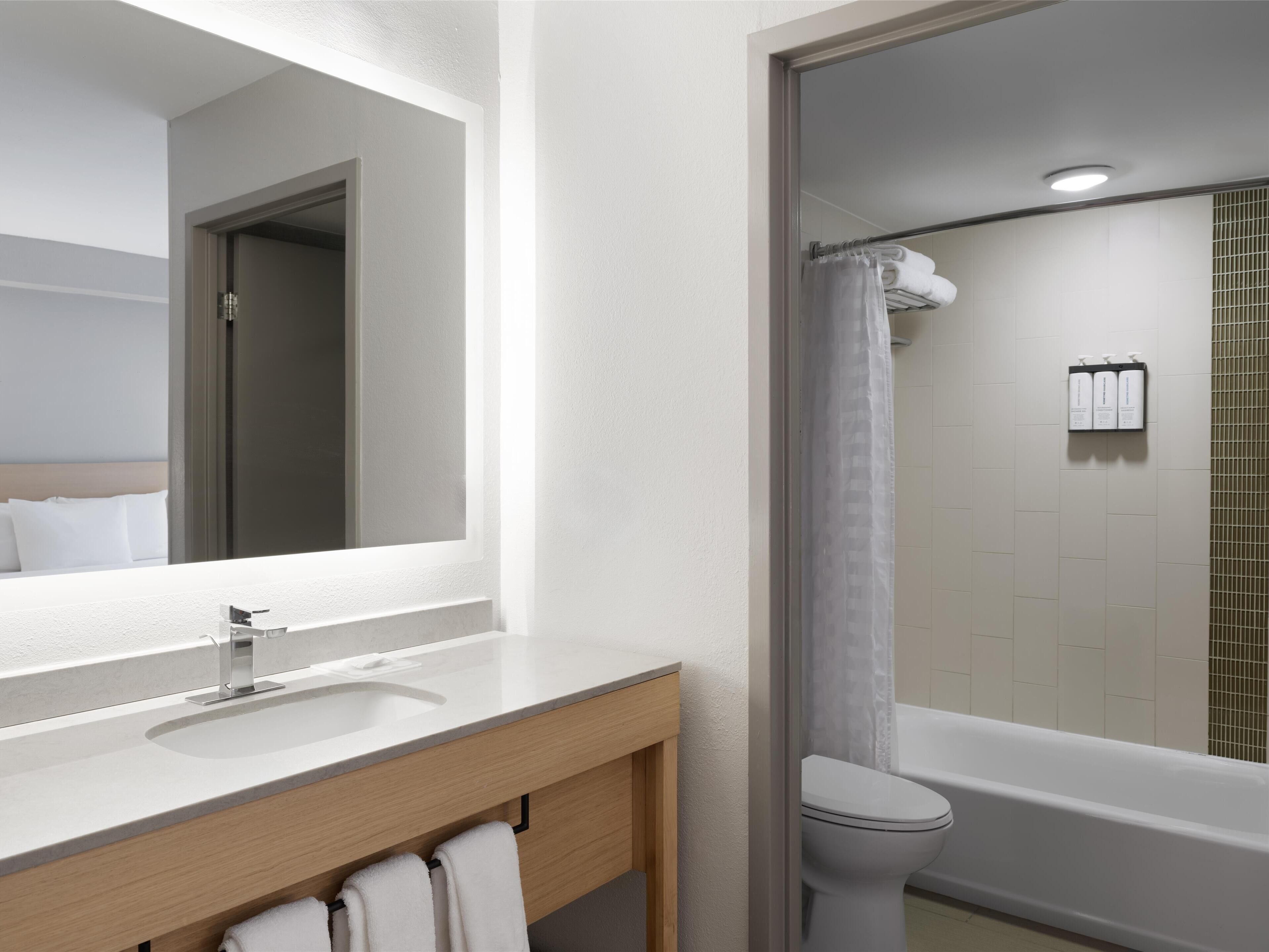 combined shower/bathtub, designer toiletries, hair dryer, towels