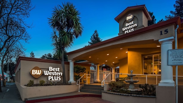A hotel entrance with a sign reading "Best Western Plus" and a number "15" on the building.