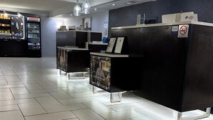 A reception area with a counter, a refrigerator, and a poster. - Best Western Plus Jonesboro Inn and Suites (Jonesboro)