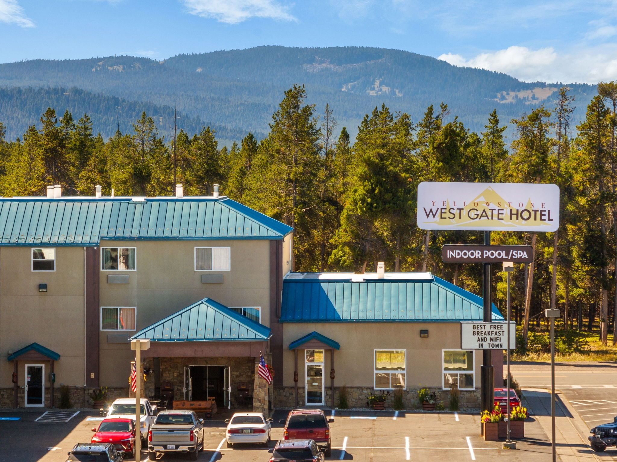 Un hôtel West Gate doté d’une piscine intérieure/d’un spa, d’une façade en pierre et offrant une vue sur les montagnes.