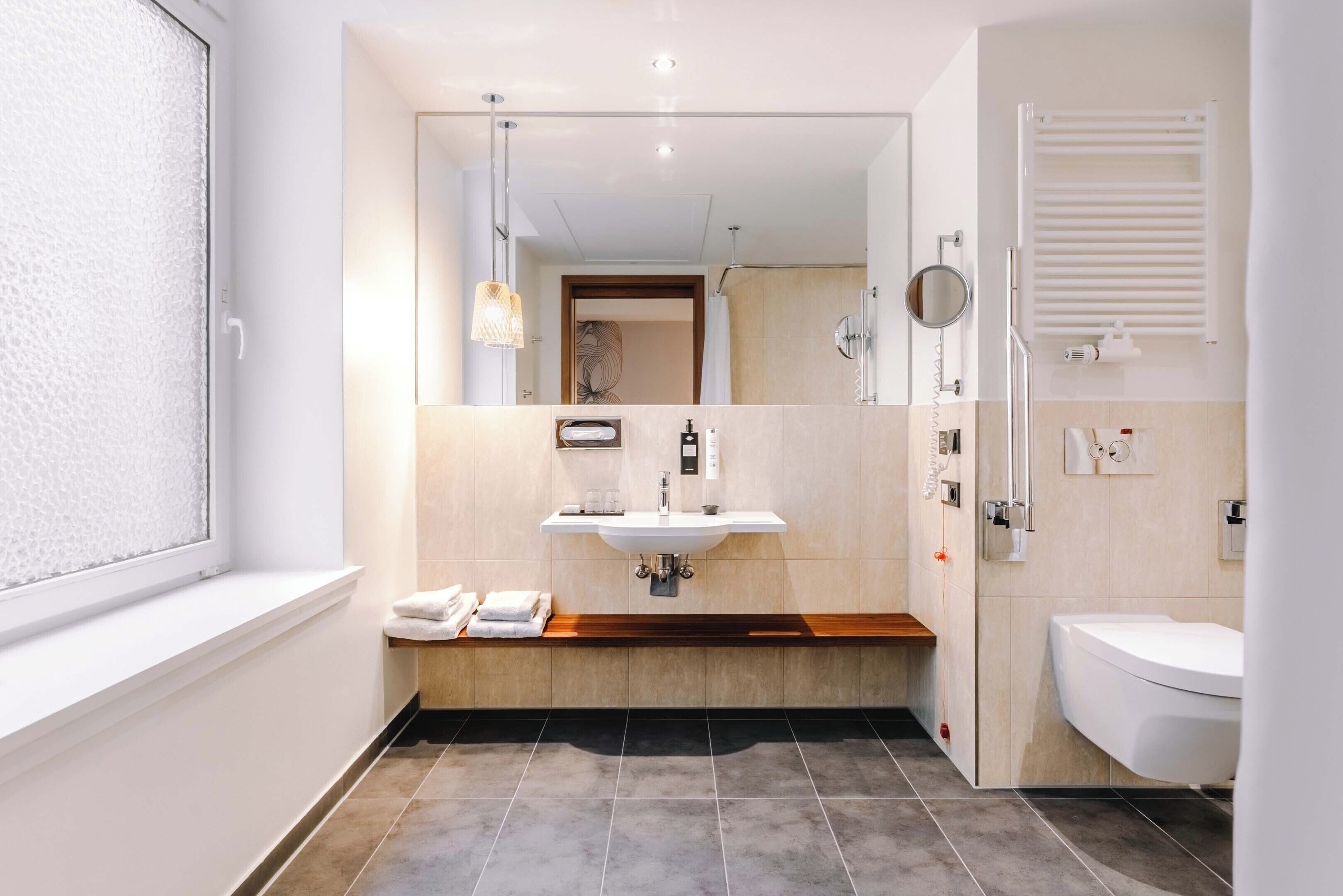 accessible room, 1 king bed | bathroom | rainfall showerhead, hair dryer, towels, soap