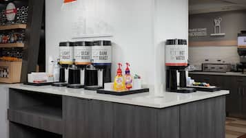 A coffee station with three coffee dispensers labeled 'Light Roast,' 'Decaf,' and 'Dark Roast,' and a 'Hot Water' dispenser.