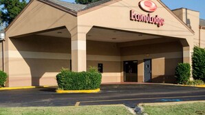 Un hotel con entrada techada, estacionamiento y un letrero que dice "EconoLodge".