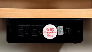A black electronic device with a white sticker that reads "Get Plugged-In! RedRoof." - Red Roof Inn Tucson South - Airport (Tucson)