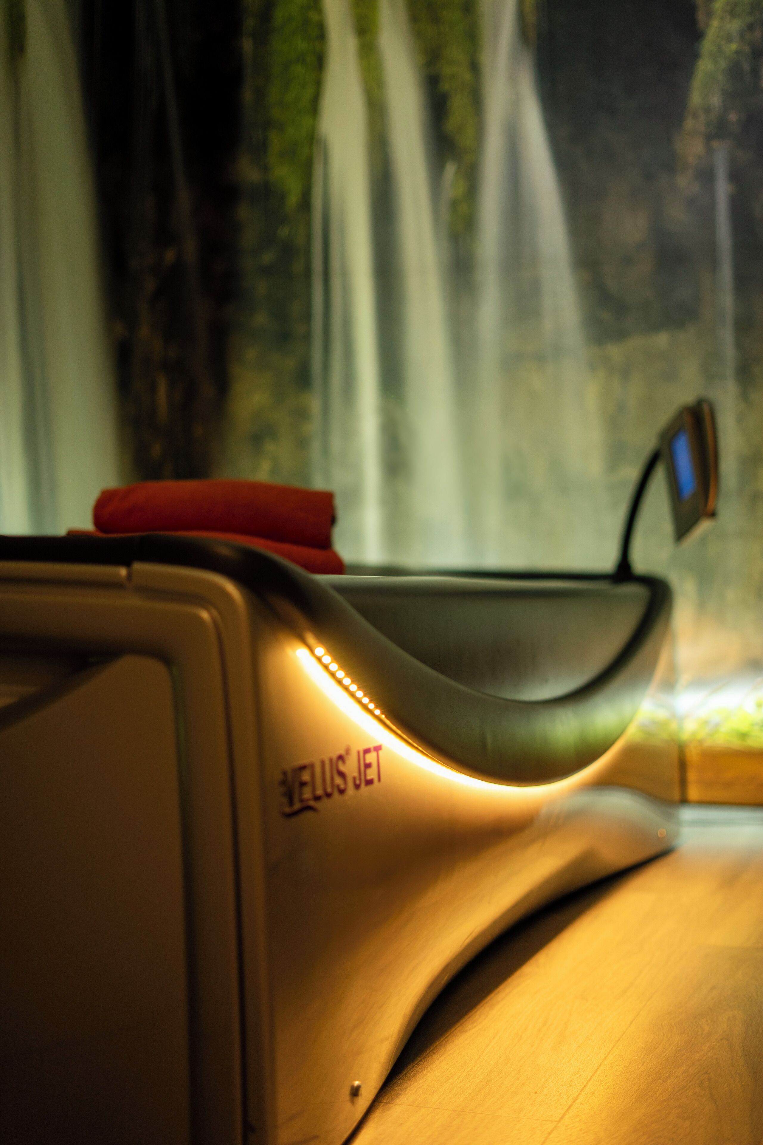 A modern, curved desk with a built-in charging station and a small digital display.