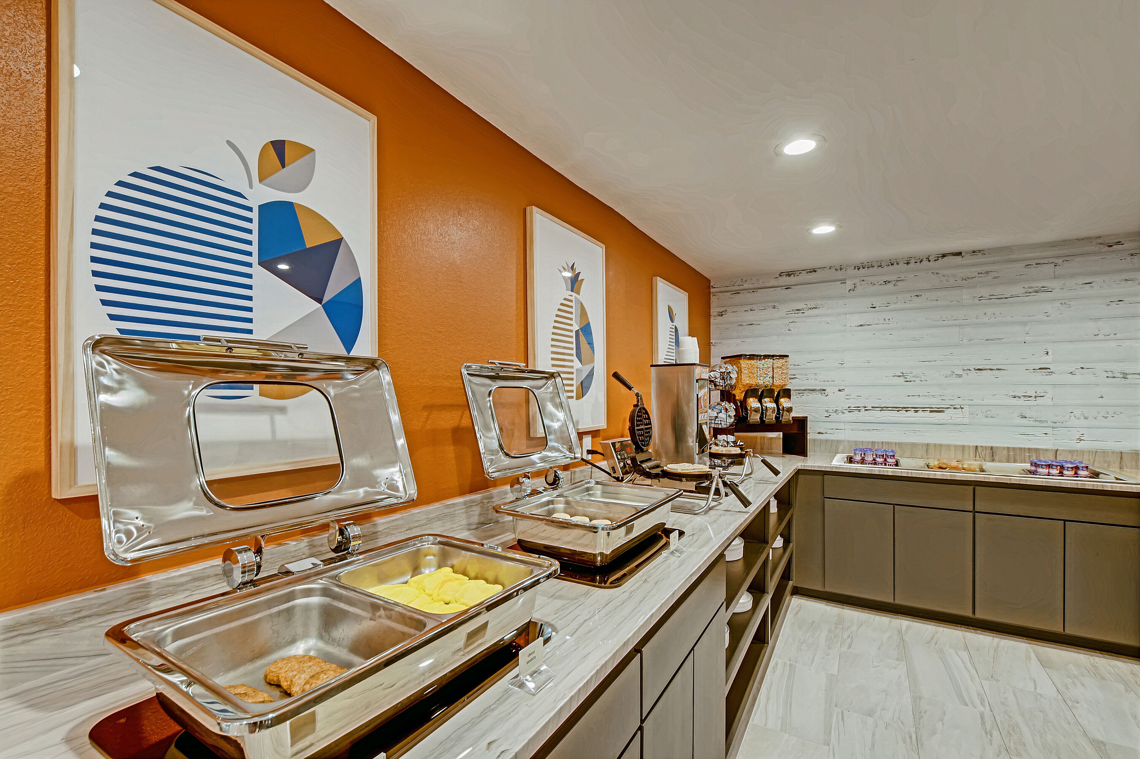A buffet setup with multiple serving stations, including trays of food and a coffee station.