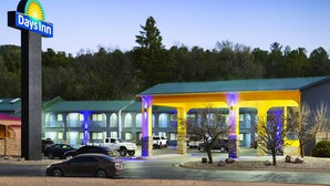 A Days Inn with a large sign, a covered parking area, and a building with multiple windows. - Days Inn by Wyndham Ruidoso Downs (Ruidoso Downs)