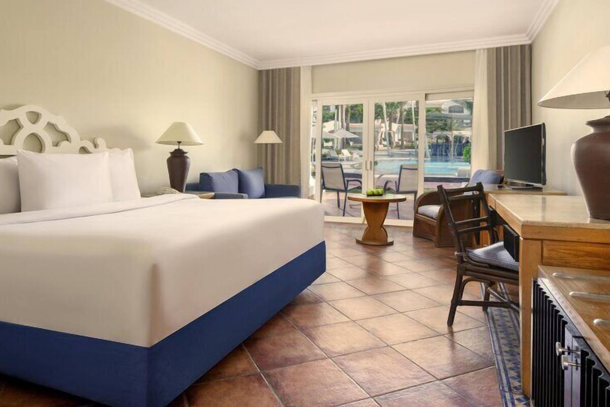 Deluxe Room, Pool View (Queen or Twin) | Minibar, in-room safe, desk, iron/ironing board