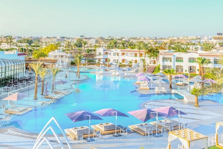 Deluxe Room, Pool View (Queen or Twin) | Minibar, in-room safe, desk, iron/ironing board