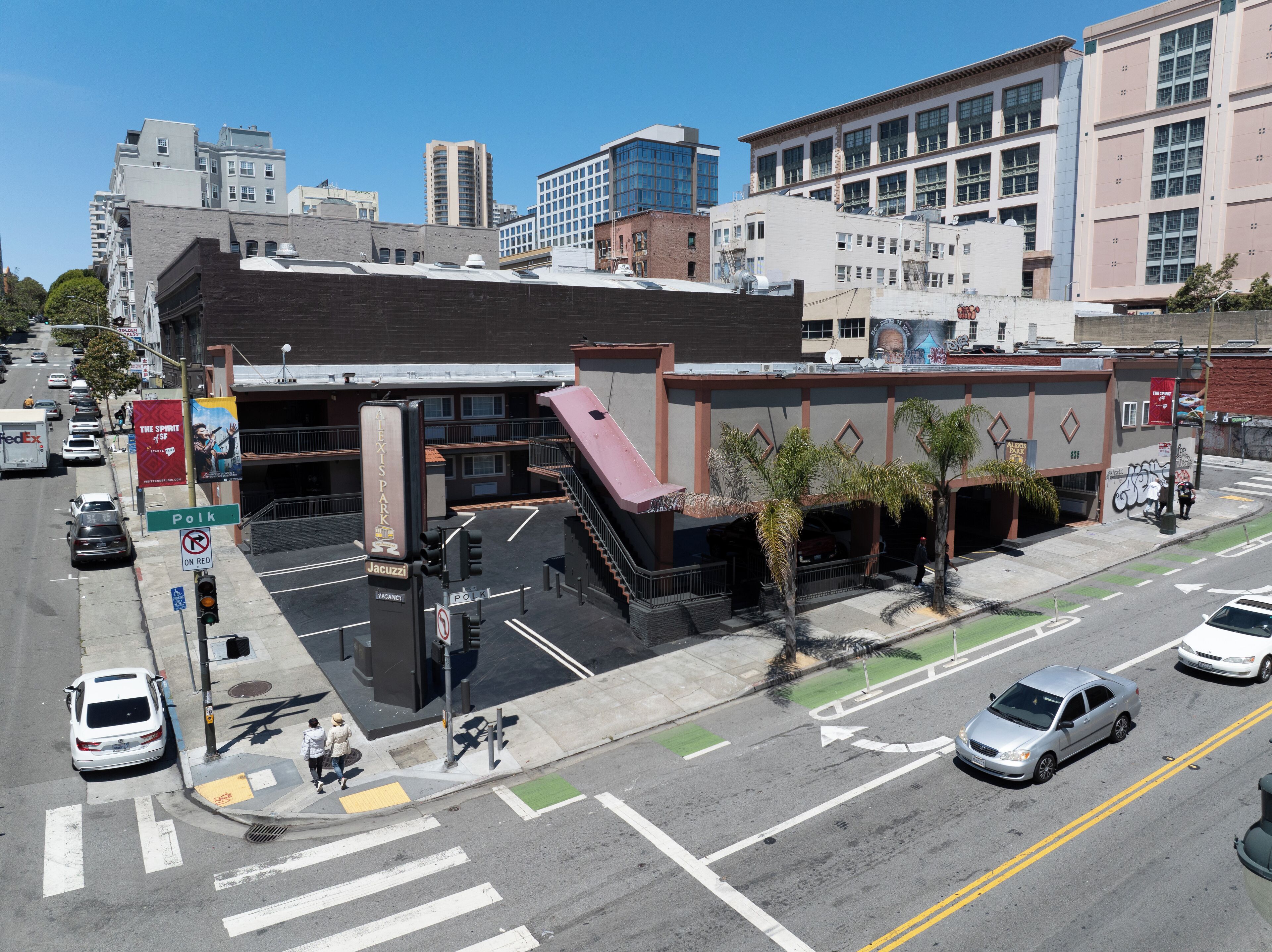 A multi-story building with a flat roof and a corner entrance.