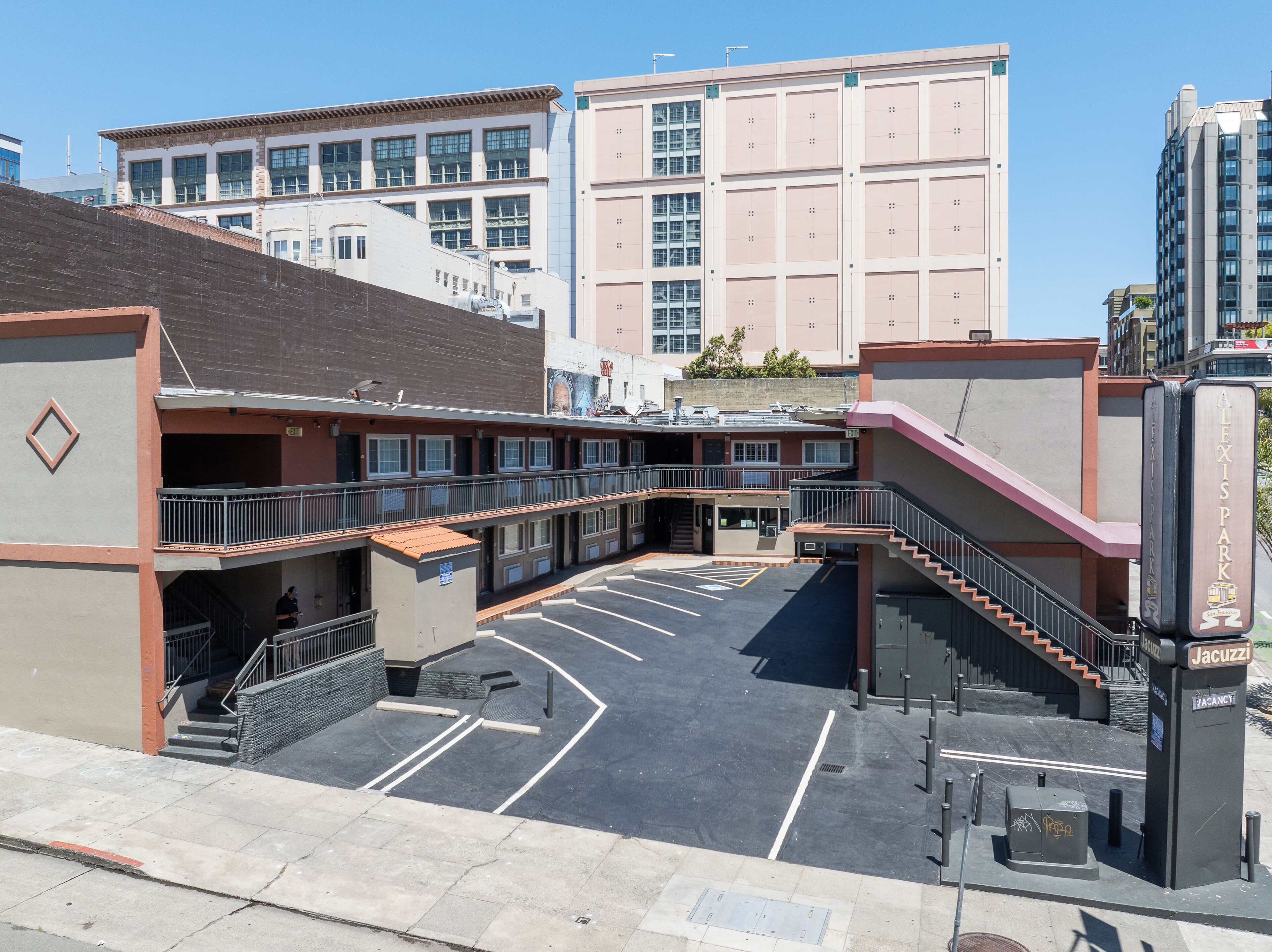 A multi-story parking garage with a central staircase and a flat parking area.
